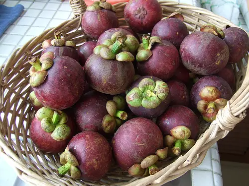 A bowl of purple mangosteens